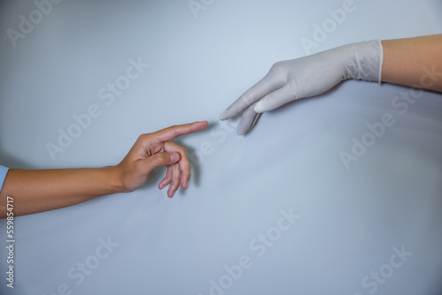 Close up of stretched hands approaching one another
