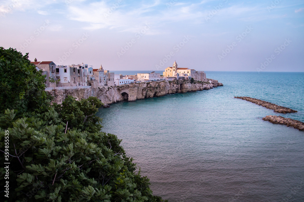 Scenic sunset view over historic old town and church of San Francesco, Vieste, Gargano, Apulia, Italy	