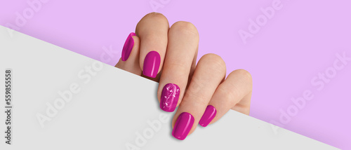Fotografija Woman's hand holding white paper. Fashionable pink nail design