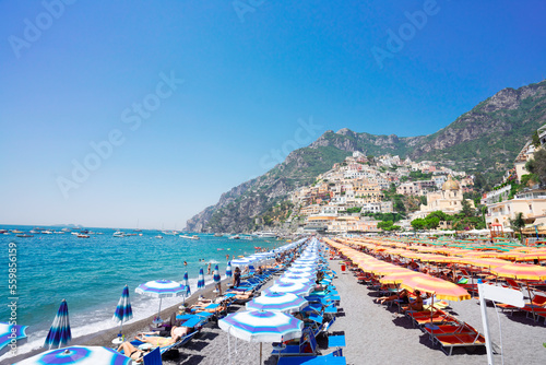 Fototapeta Naklejka Na Ścianę i Meble -  Sea and row of umbrellas on beach of Positano - famous old italian resort, Italy