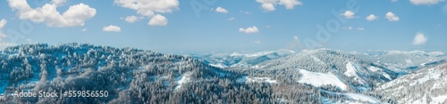 Winter Carpathian Mountains landscape with fir forest and lonely house on slopes (Skole, Lviv Oblast, Ukraine).
