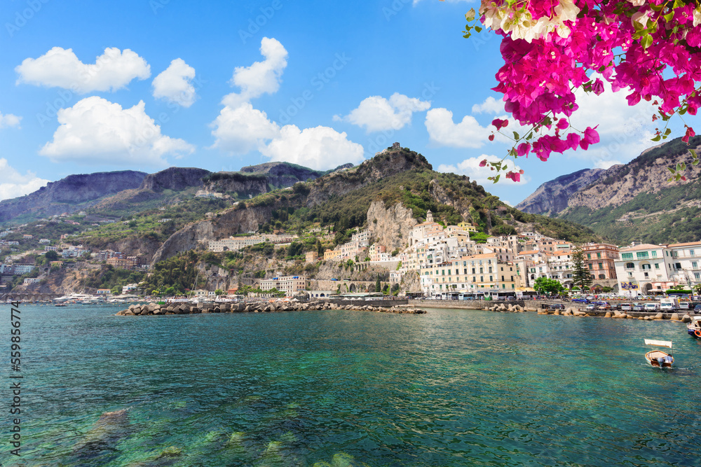 Amalfi town embankment and Tyrrhenian sea waters with flowers, Italy