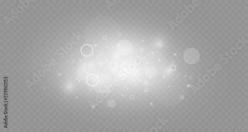 Dust sparks and stars shine with a special light. Christmas light effect. Glittering particles of magic dust.Vector sparkles on a transparent background.