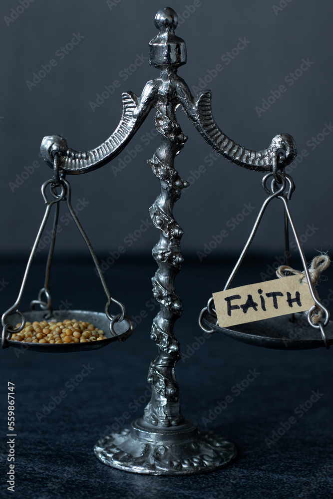 Ancient scale of justice with mustard seeds and handwritten word "faith
