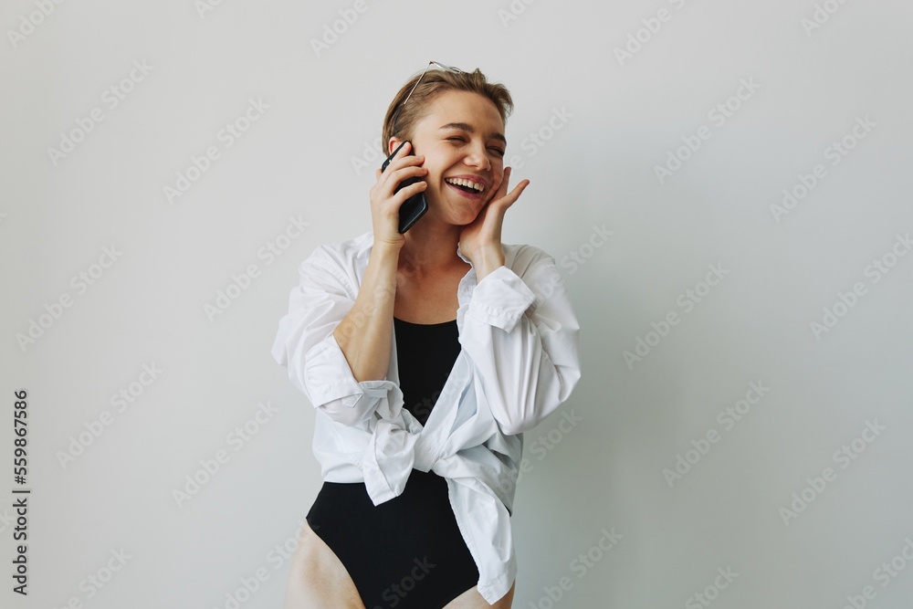 Teenage girl smiling and laughing talking on the phone, video call, chatting online Teenage girl smiling and laughing talking on the phone, video call, chatting online