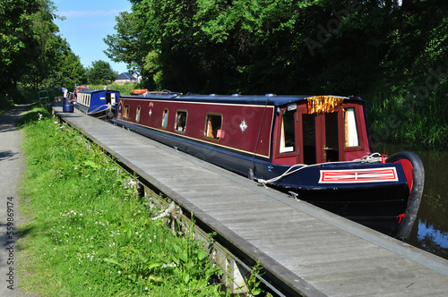 Traditional Canal Narrow Boat Moored beside  Modern Jetty 