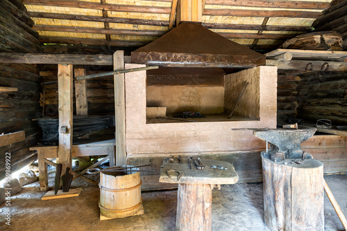 Interior of an old country forge with anvil and the tools