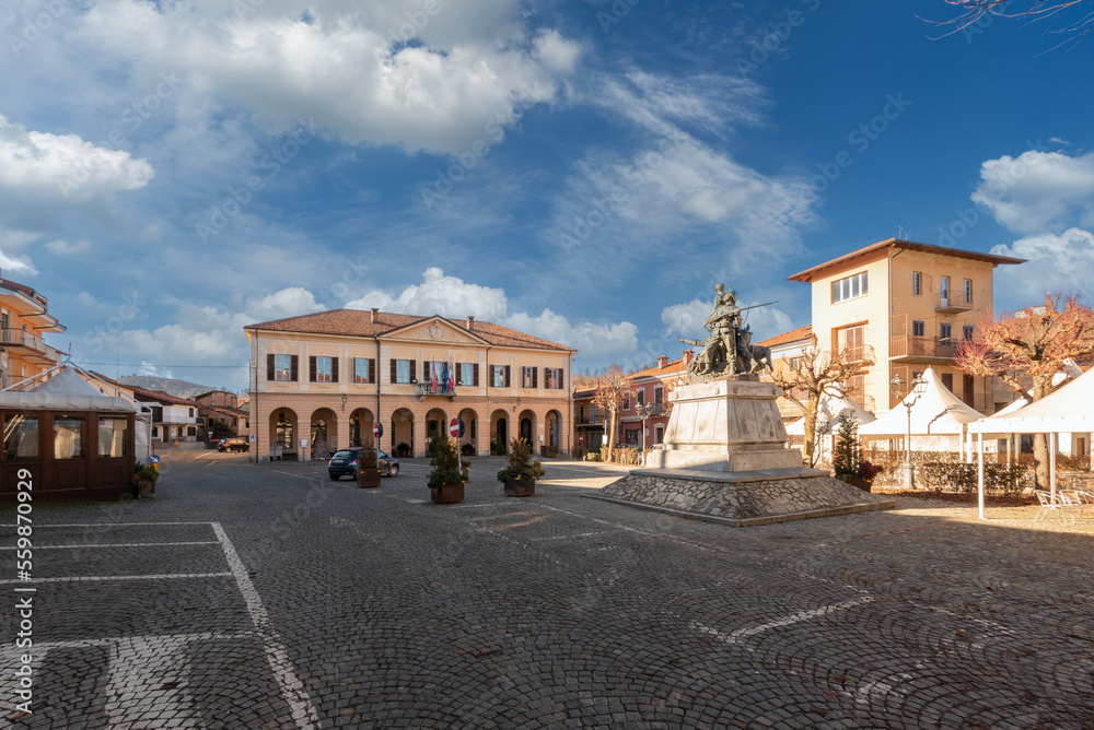 Peveragno, Cuneo, Italy - January 09, 2023: piazza Pietro Toselli with the town hall in neoclassical style and the monument to Major Pietro Toselli