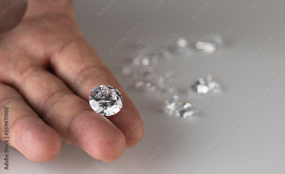 Gem stones diamonds of different cuts and sizes on the desktop of diamond dealer evaluating quality of polished diamonds. High quality photo Gem stones diamonds of different cuts and sizes on the desktop of diamond dealer evaluating quality of polished diamonds. High quality photo