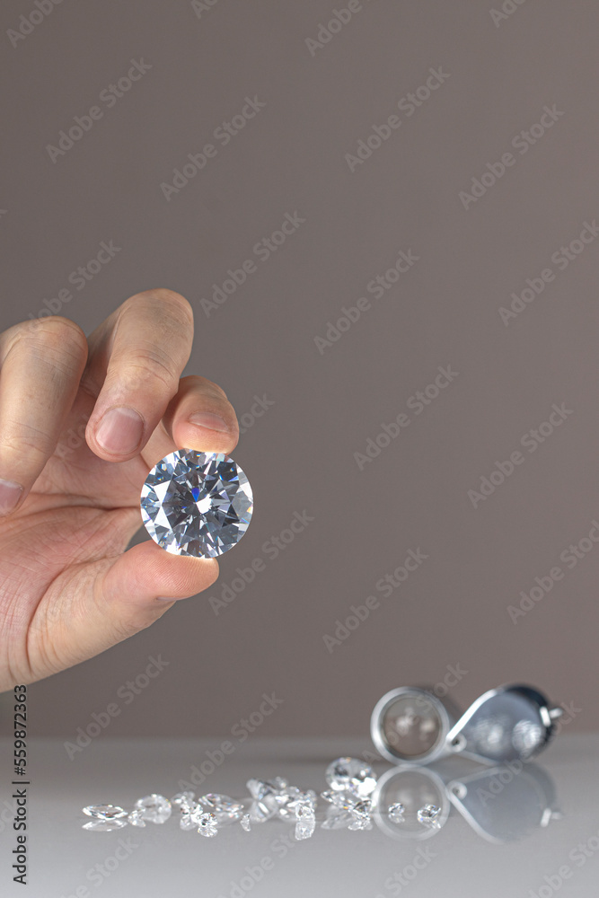Gem stones diamonds of different cuts and sizes on the desktop of diamond dealer evaluating quality of polished diamonds. High quality photo Gem stones diamonds of different cuts and sizes on the desktop of diamond dealer evaluating quality of polished diamonds. High quality photo