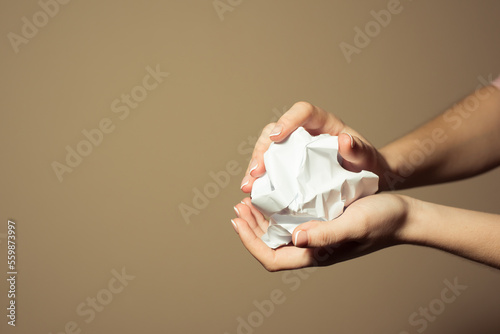crumpled paper in hand