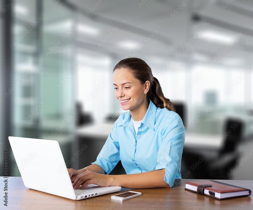 Happy young woman in office work with laptop Happy young woman in office work with laptop