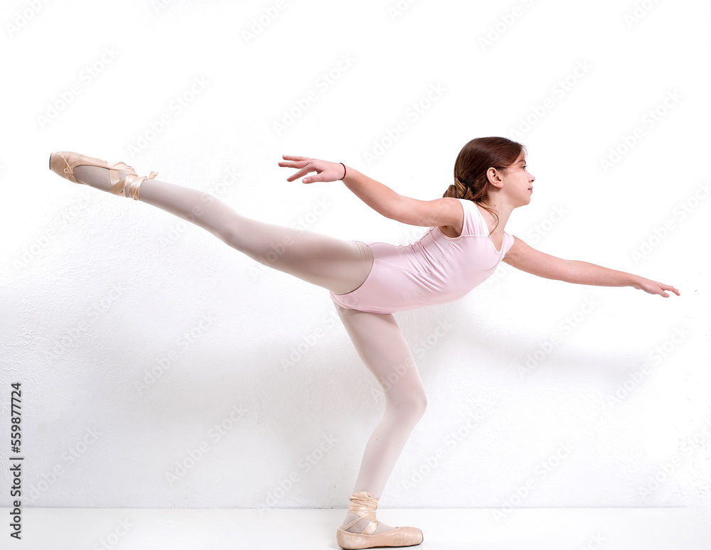 Little flexible girl ballerina in a closed swimsuit, doing gymnastic exercises on pointe shoes on a white background. Grace in motion, in action. Little flexible girl ballerina in a closed swimsuit, doing gymnastic exercises on pointe shoes on a white background. Grace in motion, in action.