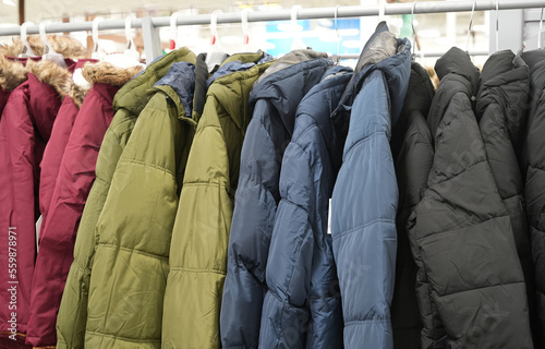 various collection winter coats hanging on a clothes rack