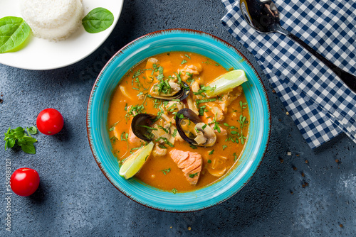 Tom Yam soup with seafood and salmon top view