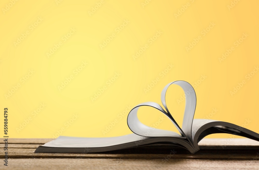 Love concept. Open reading book an pages in heart form Love concept. Open reading book an pages in heart form