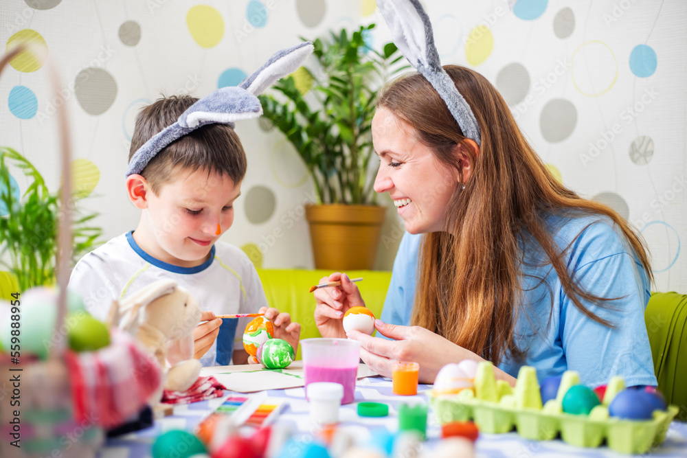 Happy Easter. A mother and her son painting Easter eggs Happy Easter. A mother and her son painting Easter eggs