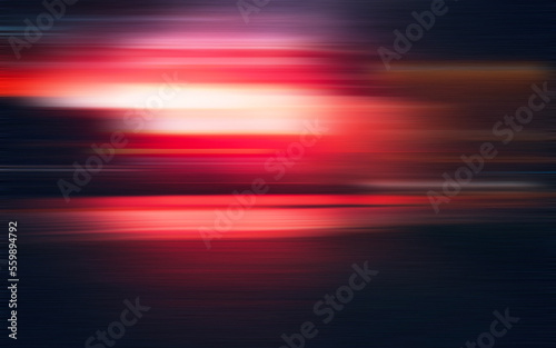 Abstract background red light and streaks are moving fast across a dark background.