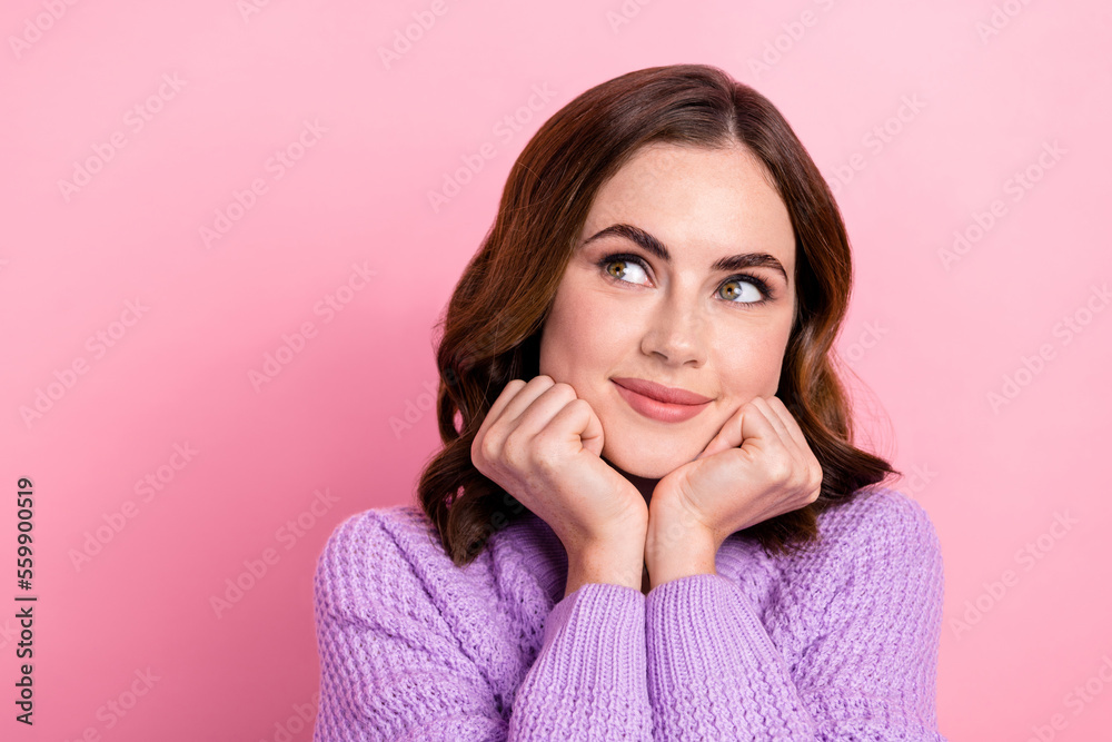Portrait of dreamy satisfied optimistic girl with curly hairdo dressed violet pullover look empty space isolated on pink color background Portrait of dreamy satisfied optimistic girl with curly hairdo dressed violet pullover look empty space isolated on pink color background