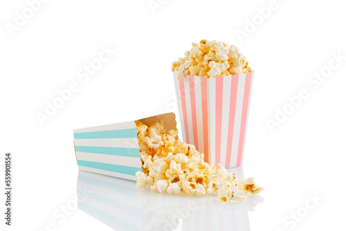 Two pink and blue striped carton buckets with tasty cheese popcorn, isolated on white background. Box with scattering of popcorn grains. Movies, cinema and entertainment concept.