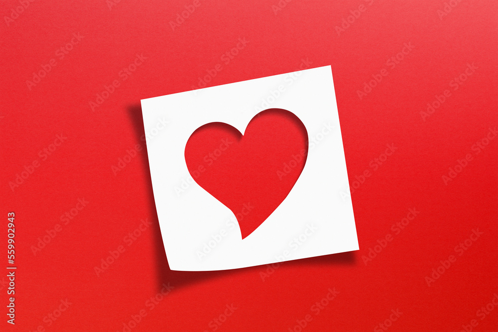 Heart shaped on note paper with red background