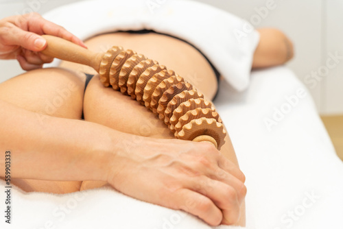 Close up of woman on maderotherapy anticellulite massage treatment at beauty spa salon. High quality photo photo