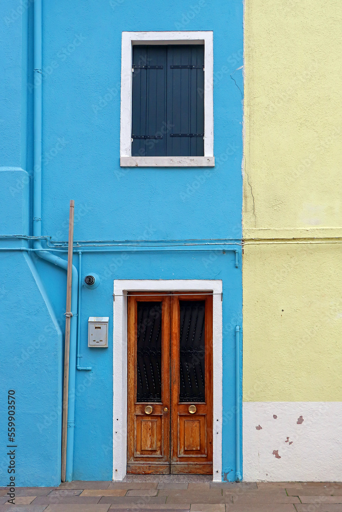 Retro entrance door and window on blue facade