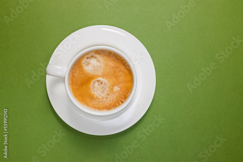 Cup of fresh espresso on the green background