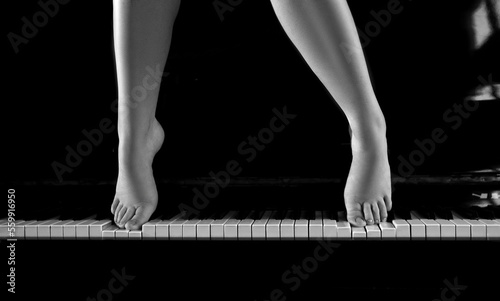 women's feet on the piano blackandwhite photo