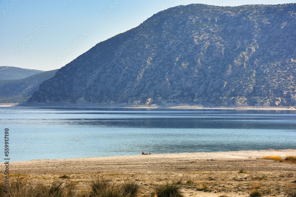 Beach Of Salda Lake In Burdur Turkey A Woman Sunbathing On The Beach