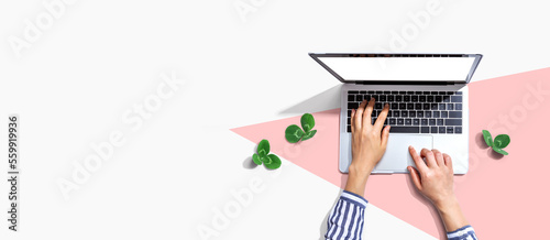 Laptop computer with shamrock leaves - flat lay