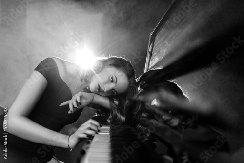 Pianist musician piano music playing. Musical instrument grand piano with woman performer.