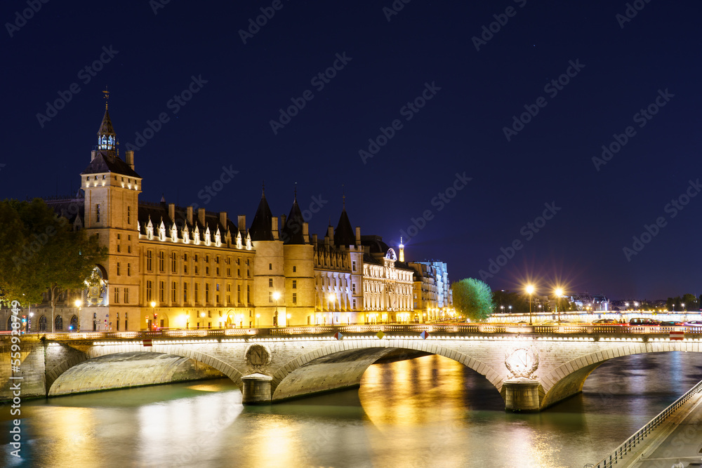 Pont Change bridge and Conciergerie at night in Paris. France