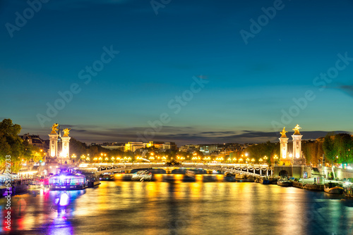 Pont Alexandre III bridge at sunset over Seine river in Paris. France