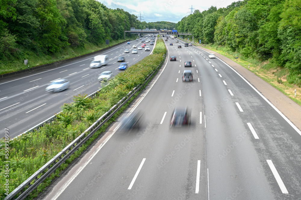 Blurred Cars on highway during rush hour in city. Driving car. Automobile driving on freeway. Moving cars, buses. Blurred Cars on highway during rush hour in city. Driving car. Automobile driving on freeway. Moving cars, buses.