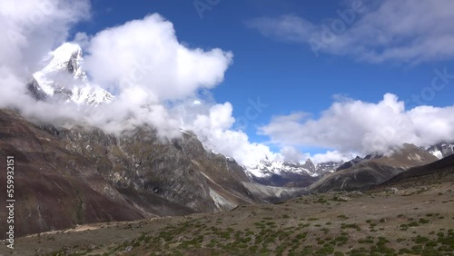 Lobuche Valley with hills and snow covered mountains
 blue sky with dramatic clouds, Everest, Nepal,2023
 photo