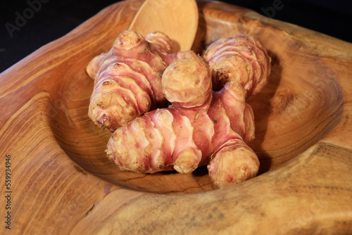 Unpeeled and raw Jerusalem artichokes or Topinambur on a table