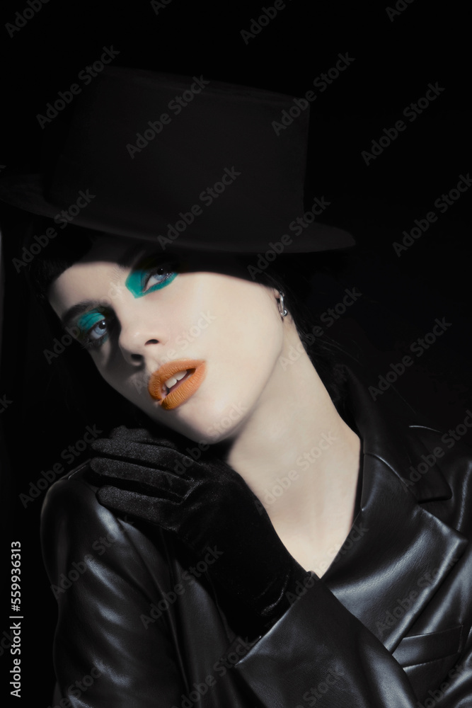 Art-deco makeup at young model with orange lips, green eyeshadows Art-deco makeup at young model with orange lips, green eyeshadows