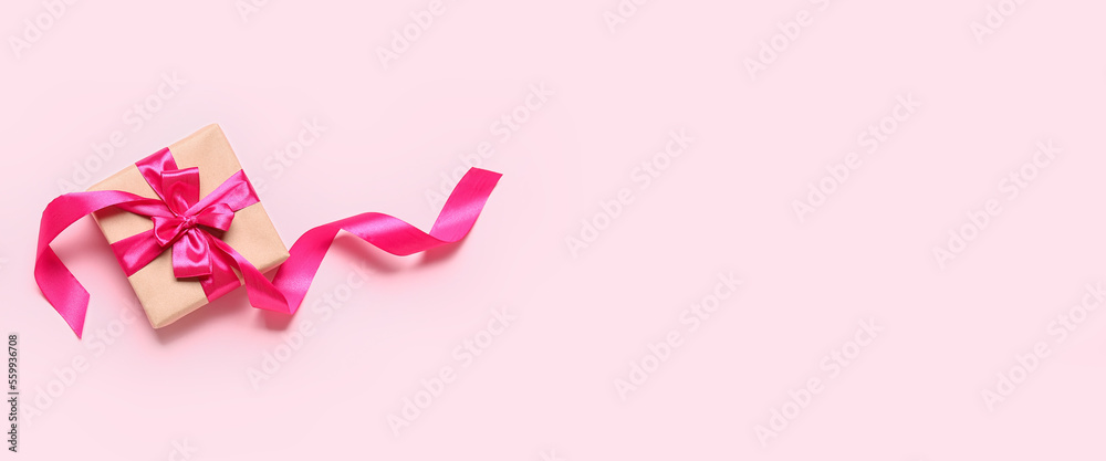 Gift box for Valentine's Day on pink background with space for text