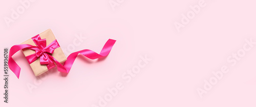 Gift box for Valentine's Day on pink background with space for text