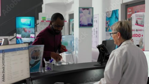 Wallpaper Mural Young man taking pharmaceutical products from drugstore shelves, buying boxes of medicaments at pharmacy counter. Male customer looking at medical packages of vitamins at desk. Torontodigital.ca