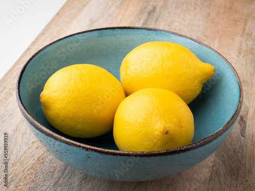 Three lemons lying in a bowl. Close-up. 