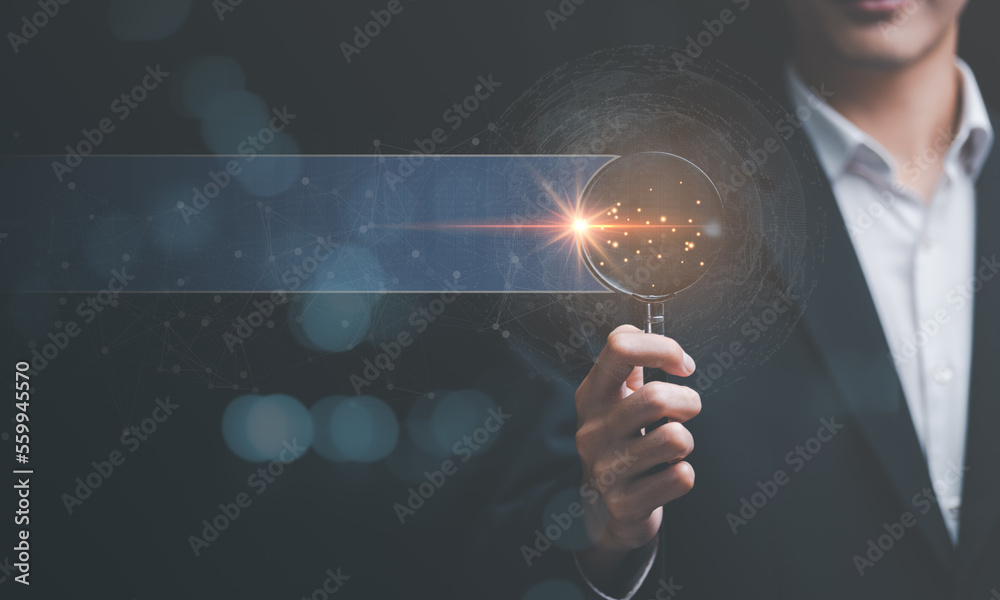 businessman holding a magnifying glass Displays a search for information he is interested in through online websites,keyword search concept to find information from online websites,website link search - obrazy, fototapety, plakaty 
