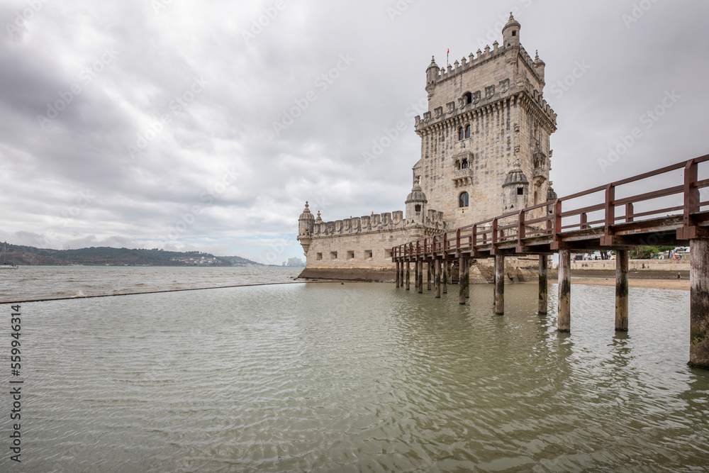 Torre de belem building in Lisbon with a wooden walkway on a cloudy day