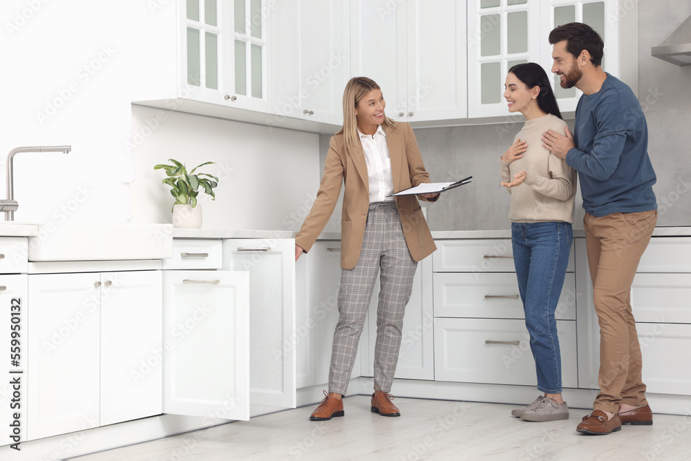 Real estate agent showing new apartment to couple Real estate agent showing new apartment to couple