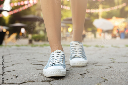 Woman in stylish shoes walking on city street, closeup