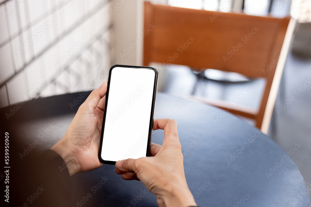 cell phone blank white screen mockup.hand holding texting using mobile on desk at office.background empty space for advertise.work people contact marketing business,technology cell phone blank white screen mockup.hand holding texting using mobile on desk at office.background empty space for advertise.work people contact marketing business,technology