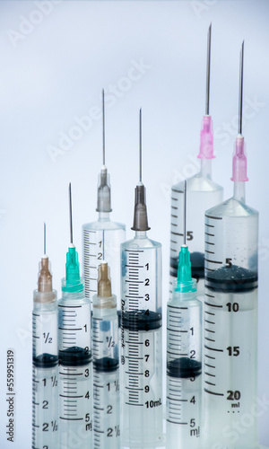 syringes with different needle colours isolated on white
