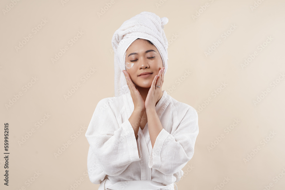Portrait of beautiful Asian woman on cream background closeup. Girl with clean skin. Isolated on cream background.