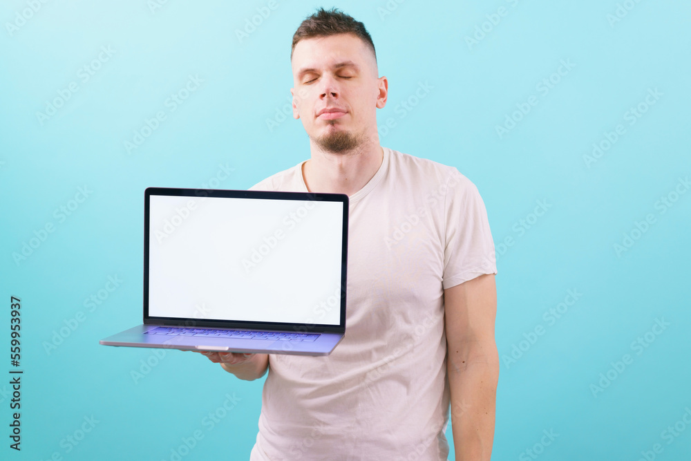 A man dreaming with closed eyes and holding a laptop with an empty blank screen on blue background. Occupation. Online. Relaxed. Shirt. Student. Wireless. Head. Dreamy. Dream. Vision. Thinking A man dreaming with closed eyes and holding a laptop with an empty blank screen on blue background. Occupation. Online. Relaxed. Shirt. Student. Wireless. Head. Dreamy. Dream. Vision. Thinking